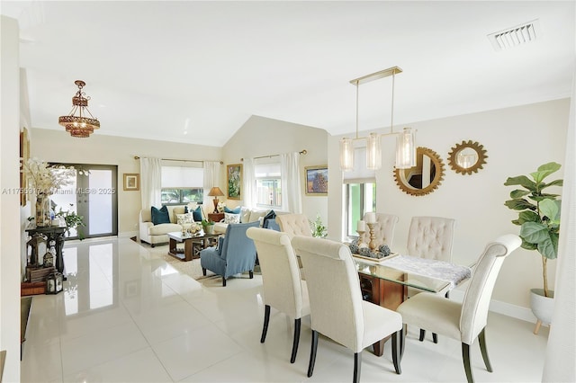 dining room with visible vents, vaulted ceiling, baseboards, and light tile patterned flooring