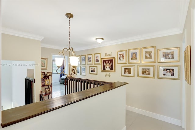 corridor with light tile patterned floors, baseboards, and ornamental molding