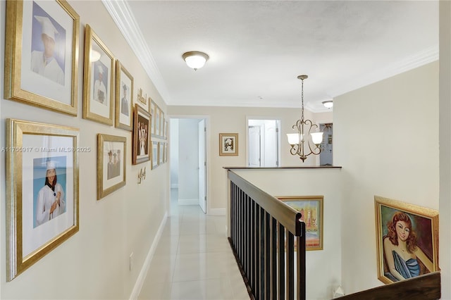 corridor featuring light tile patterned floors, baseboards, a chandelier, and crown molding