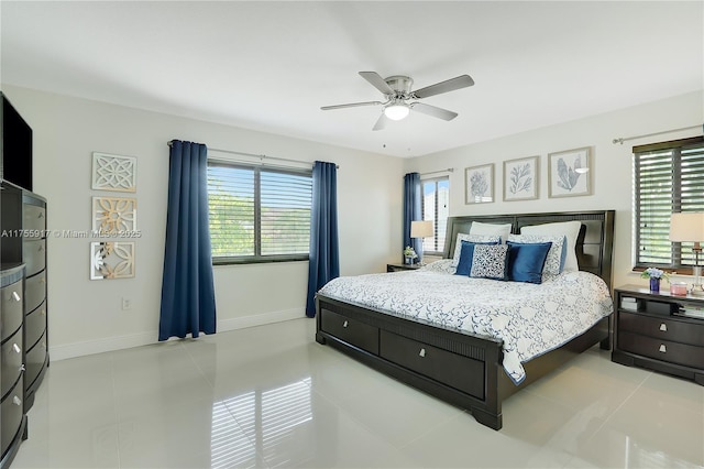 bedroom with light tile patterned floors, ceiling fan, and baseboards