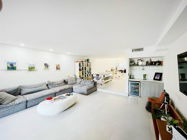 living room with a bar, visible vents, and recessed lighting