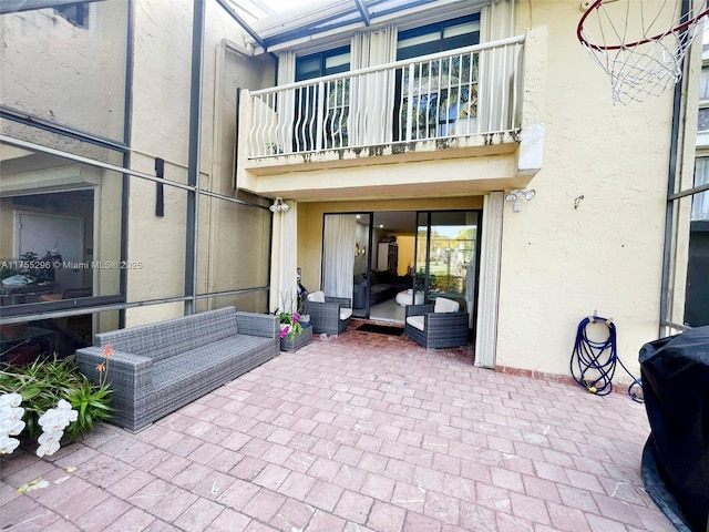 view of patio featuring a balcony