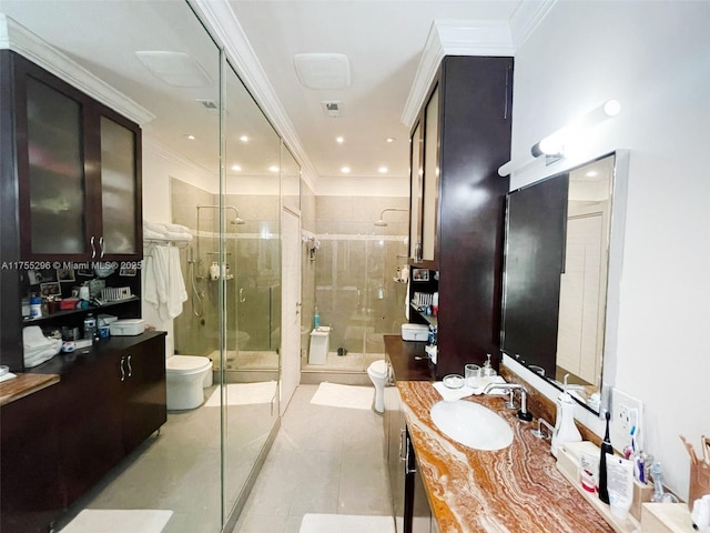 full bathroom with tile patterned flooring, toilet, vanity, a shower stall, and crown molding