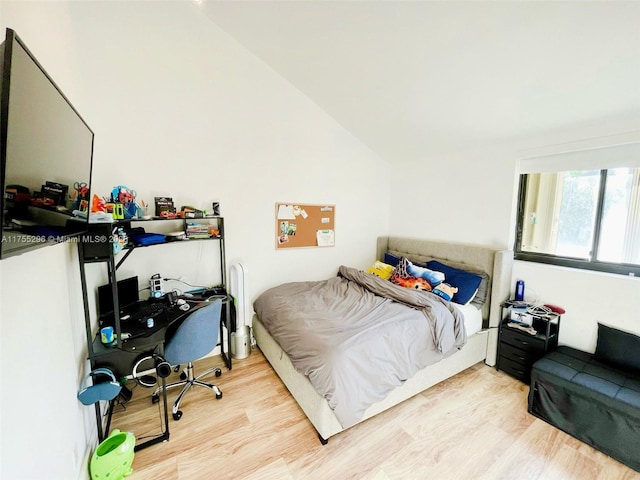 bedroom featuring vaulted ceiling and wood finished floors