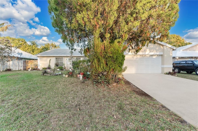 ranch-style home featuring stucco siding, an attached garage, a front yard, fence, and driveway