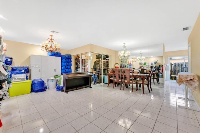 tiled dining area featuring visible vents and an inviting chandelier