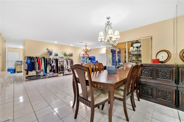 dining area featuring a chandelier and light tile patterned flooring