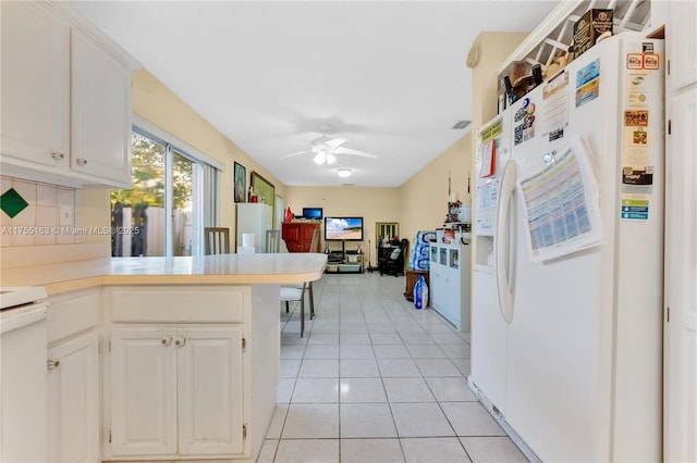 kitchen with white refrigerator with ice dispenser, decorative backsplash, a peninsula, light countertops, and light tile patterned flooring