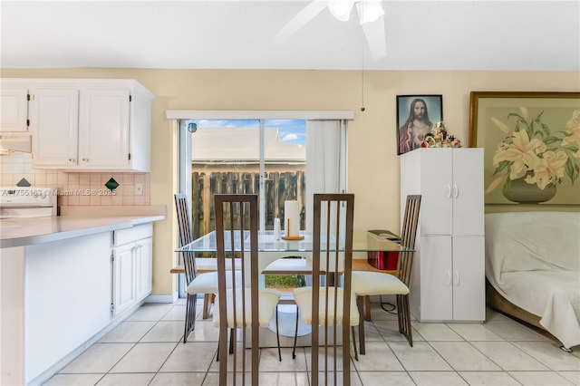 dining space featuring ceiling fan and light tile patterned floors