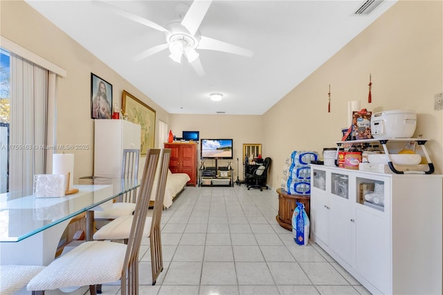 interior space featuring ceiling fan, light tile patterned flooring, visible vents, white cabinetry, and glass insert cabinets