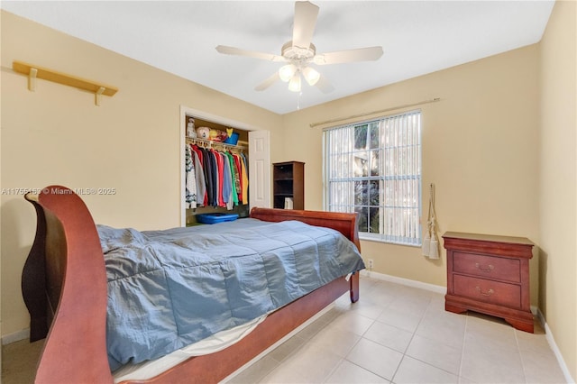 bedroom with a closet, tile patterned flooring, a ceiling fan, and baseboards