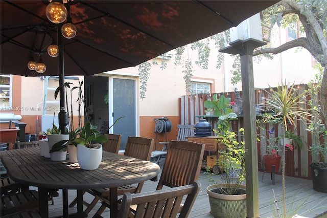 exterior space featuring outdoor dining area and a deck