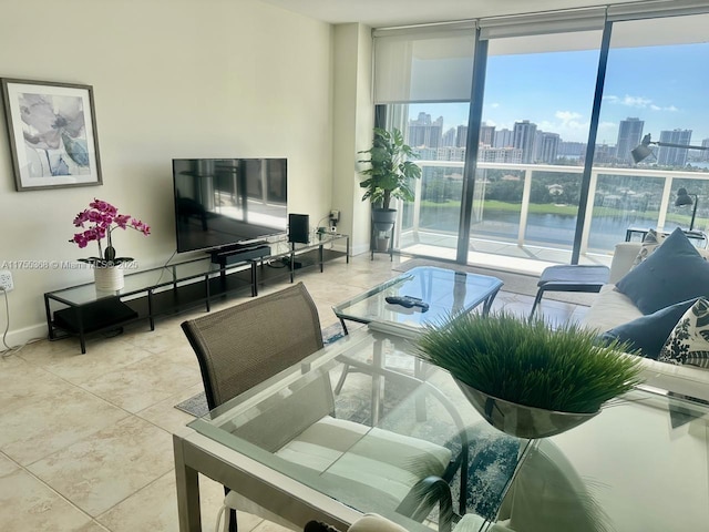 living area with a wall of windows, tile patterned flooring, and baseboards