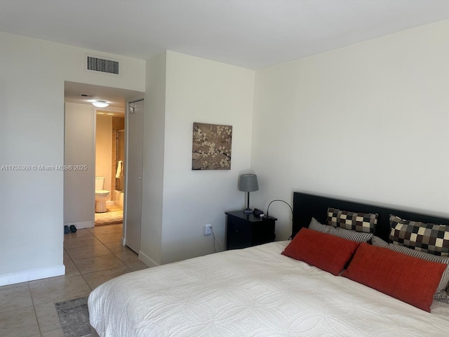 bedroom with tile patterned flooring, visible vents, and baseboards