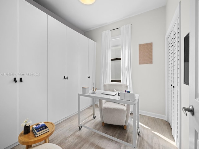 office area with light wood-type flooring and baseboards