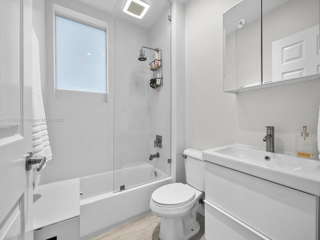 full bath with vanity, shower / bathing tub combination, wood finished floors, and toilet