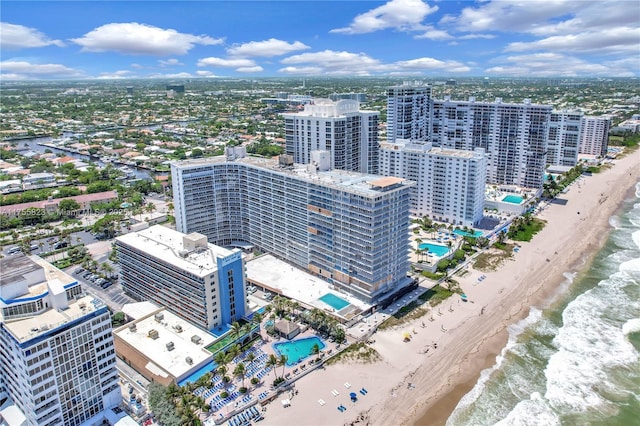 aerial view featuring a water view, a beach view, and a city view