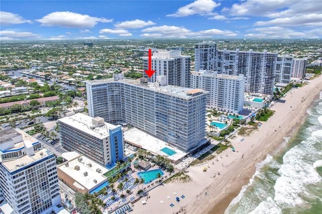 birds eye view of property featuring a water view, a city view, and a view of the beach