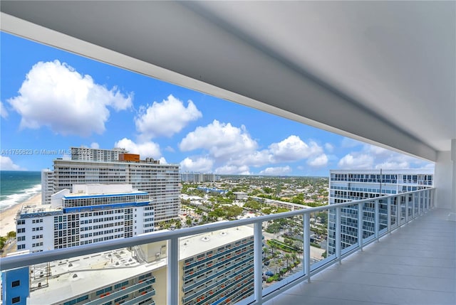 balcony featuring a water view and a city view