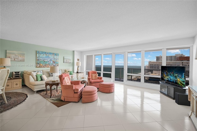 living room with a textured ceiling and light tile patterned flooring