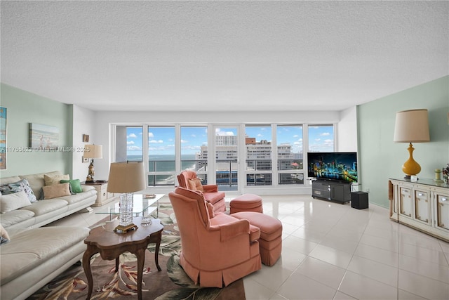 living room featuring plenty of natural light, a textured ceiling, and light tile patterned floors