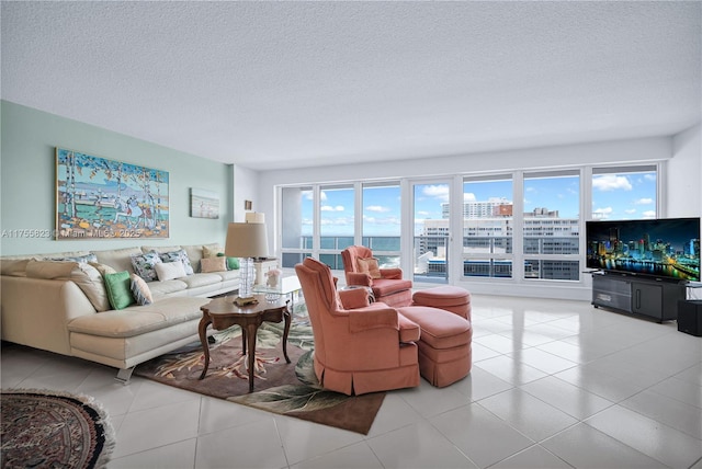 living area featuring light tile patterned floors and a textured ceiling