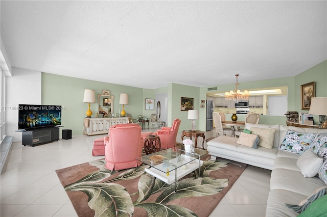 tiled living room featuring a chandelier, visible vents, and a textured ceiling