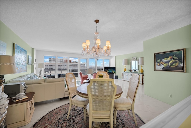 dining area with a textured ceiling, light tile patterned flooring, and a notable chandelier