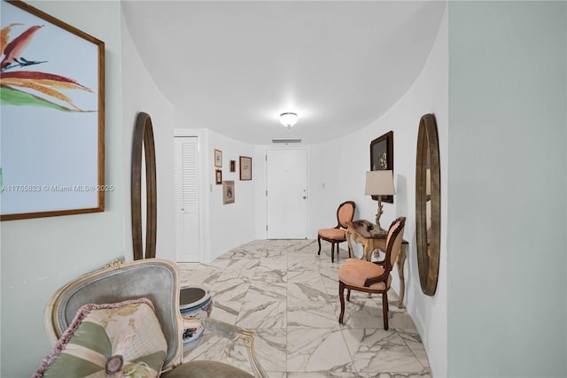 living area with marble finish floor and visible vents