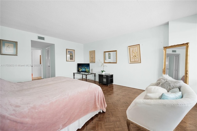 bedroom featuring visible vents and a textured ceiling