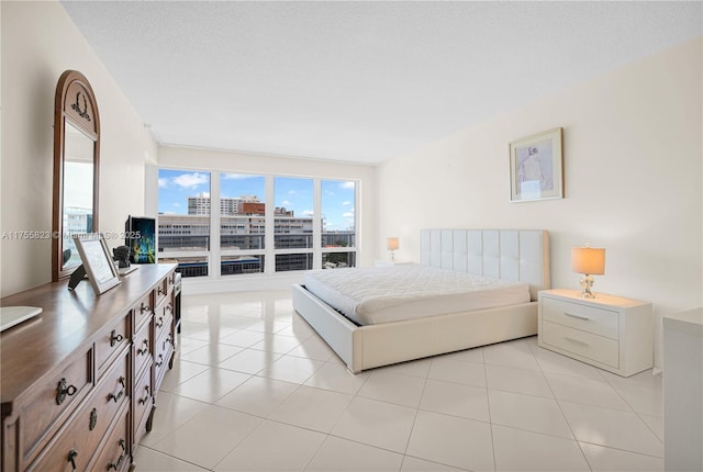 bedroom featuring light tile patterned floors and a textured ceiling