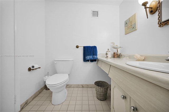 half bath with tile patterned flooring, toilet, vanity, visible vents, and baseboards