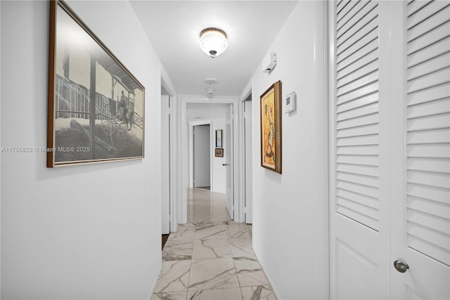 hallway featuring marble finish floor