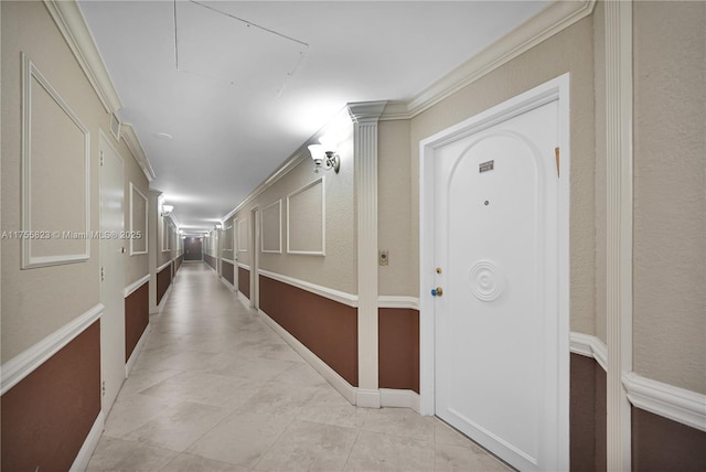 hallway featuring attic access and crown molding