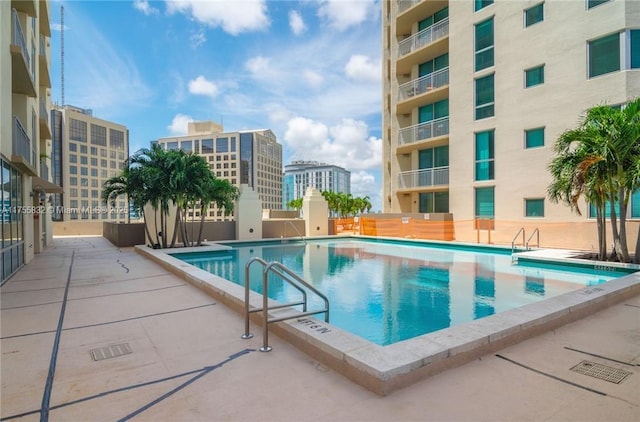 community pool featuring a city view and a patio