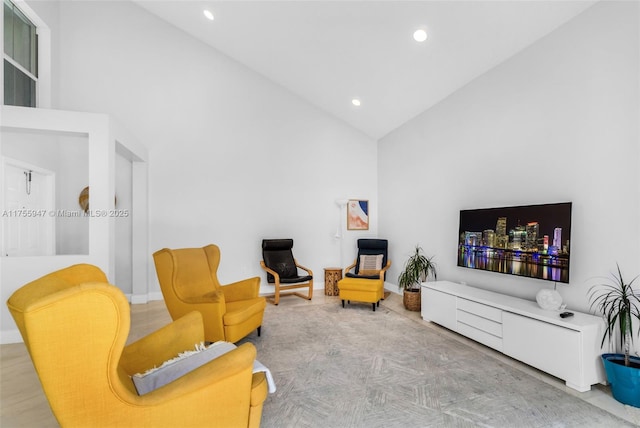 sitting room featuring baseboards, high vaulted ceiling, and recessed lighting