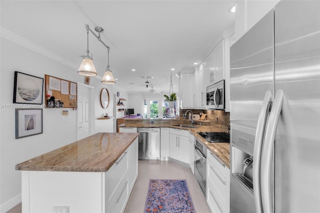 kitchen with light stone counters, stainless steel appliances, a peninsula, a sink, and tasteful backsplash