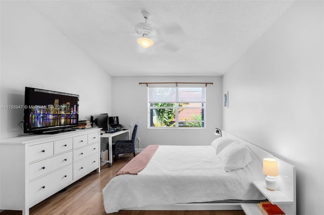 bedroom featuring ceiling fan, a textured ceiling, and wood finished floors