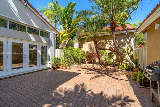 view of patio featuring french doors and fence