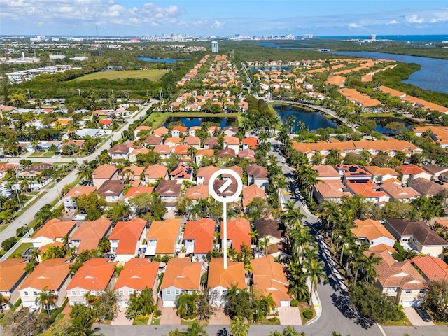 birds eye view of property with a residential view and a water view