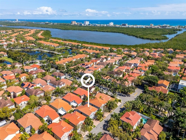 drone / aerial view featuring a water view and a residential view