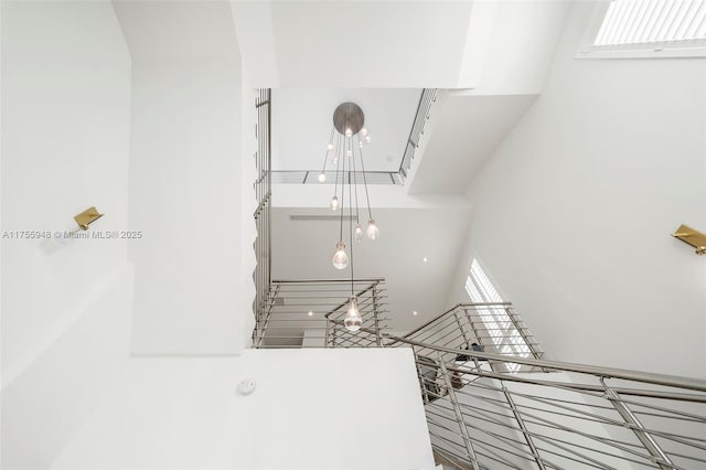 stairway featuring a high ceiling