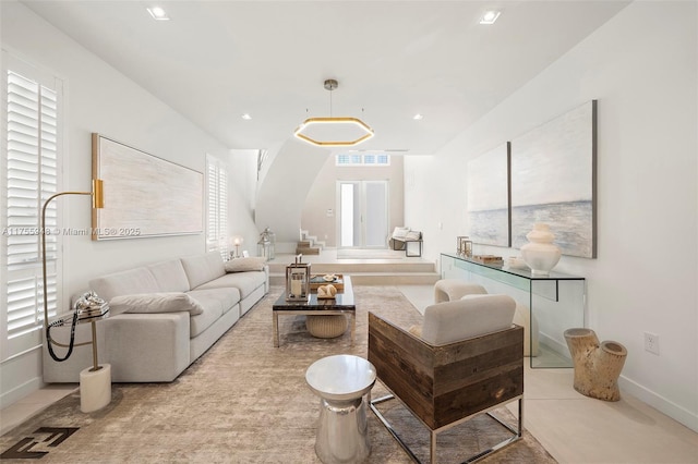 living area with baseboards, visible vents, and recessed lighting