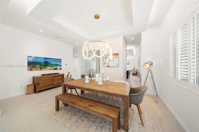 dining space featuring a chandelier, a tray ceiling, baseboards, and recessed lighting