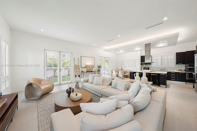 living room with light tile patterned floors and recessed lighting