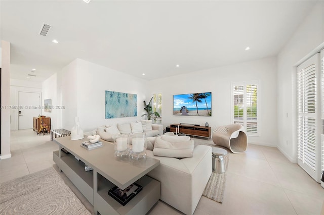 living room with light tile patterned floors, visible vents, and recessed lighting