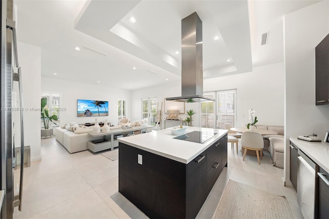 kitchen with visible vents, modern cabinets, open floor plan, island exhaust hood, and black electric stovetop