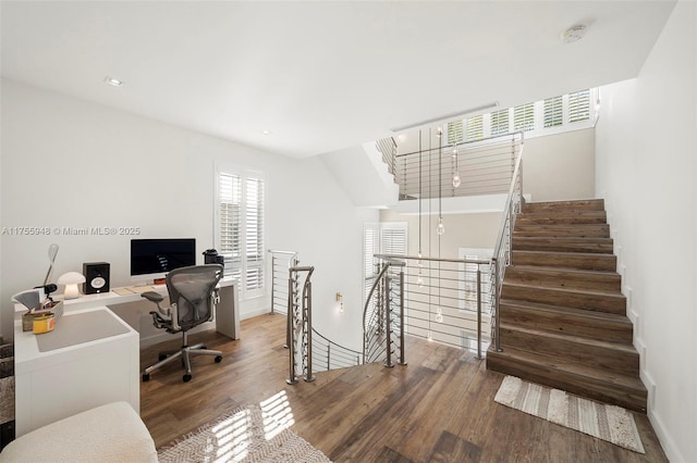 home office with baseboards and wood finished floors