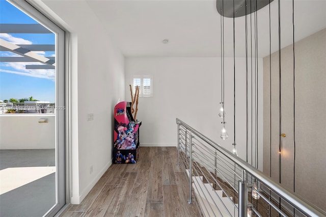 hall featuring wood finished floors and baseboards