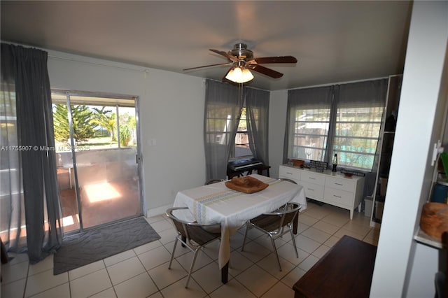 dining area featuring light tile patterned floors and a ceiling fan